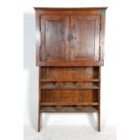 A 19th century unusual chestnut / oak upright cabinet dresser. The upright lower section with a