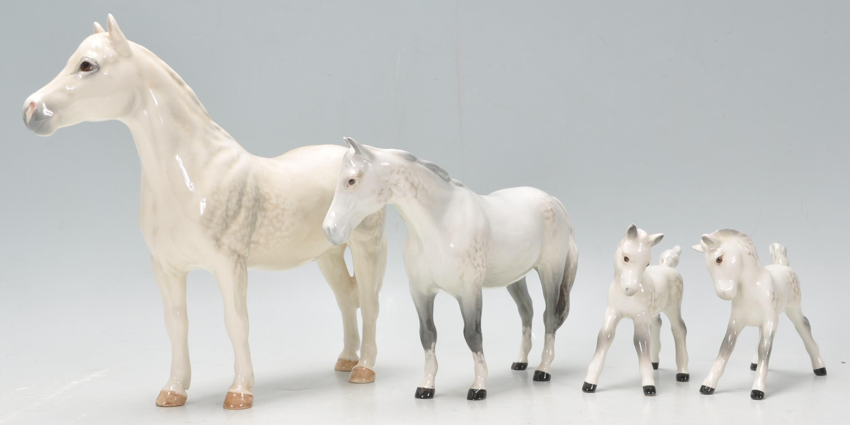 A  collection of 2 Beswick horse porcelain figurines to include 2 dapple grey coloured mares, all