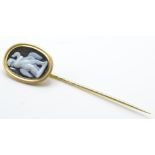 An antique gold cameo stickpin. The stickpin set w