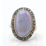 A 9ct rose gold opal and diamond ring.