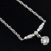 A 14ct white gold and diamond pendant necklace.Est