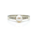 A 9ct white gold, pearl and diamond ring. The ring