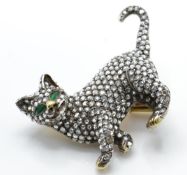 A gold emerald and diamond figural brooch pin. The