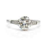 A platinum and diamond solitaire ring. The ring se