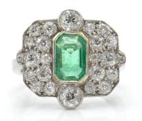 An 18ct white gold emerald and diamond ring.