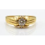 A gold and diamond solitaire ring. The ring set wi