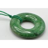 A large Chinese green hardstone roundel Bi pendant