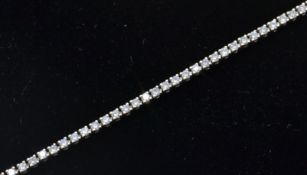 An 18ct white gold tennis bracelet set with round