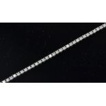 An 18ct white gold tennis bracelet set with round