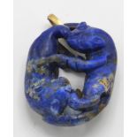 A gold and Lapis Lazuli figural pendant. The penda