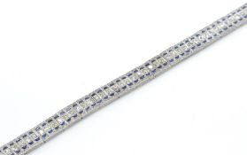 An 18t gold sapphire and diamond bracelet. Estimat