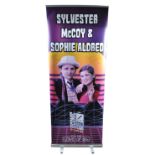 MONOPOLY EVENTS - AUTOGRAPHED BANNER - SYLVESTER MCCOY, SOPHIE ALDRED