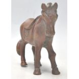 A mid 20th Century cast bronze figure in the form of a horse in a standing position having a