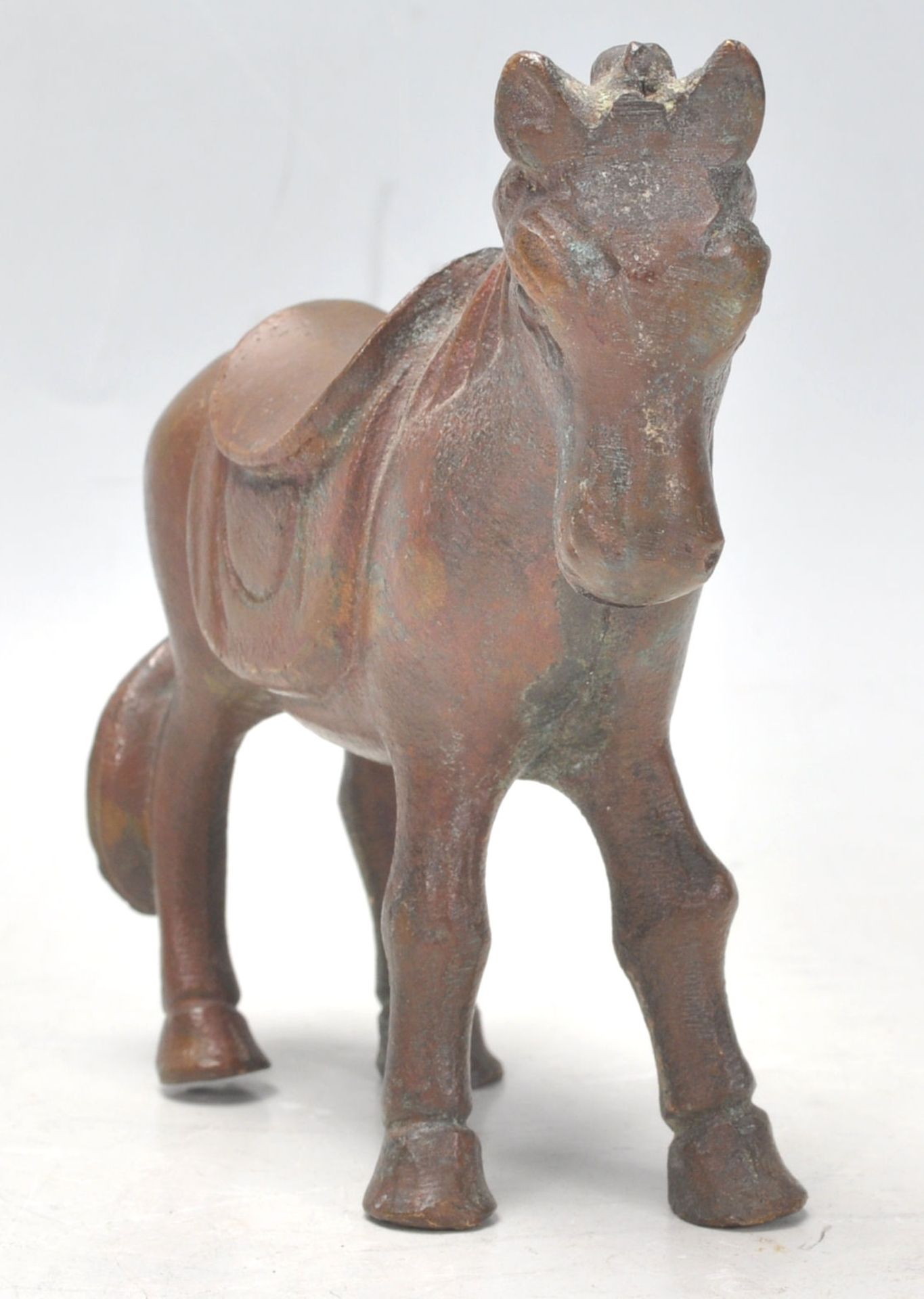 A mid 20th Century cast bronze figure in the form of a horse in a standing position having a