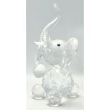 A 20th century carved crystal glass elephant set with bone tusks and black glass eyes. Measures 26cm