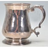 An 18th Century George II mug by Thomas Whipham of plain baluster form having a leaf clasped