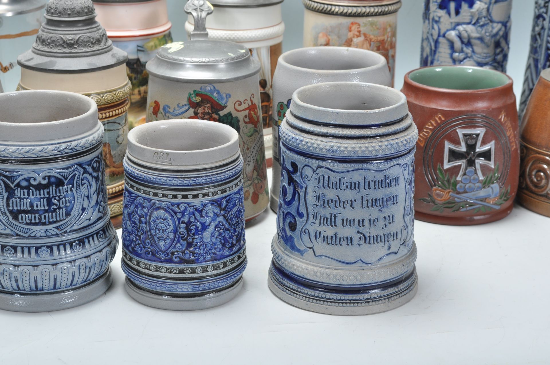 A collection of 20th Century German ceramic stein drinking glasses, many having raised blue and grey - Bild 4 aus 9