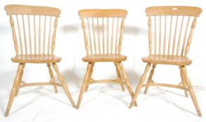 A set of three 20th Century Windsor style beech wood spindle back dining chairs having shaped