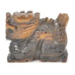 A small Chinese tiger's eye figure in the form of a dragon.