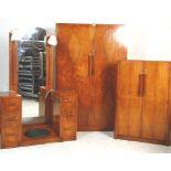 A fantastic Art Deco 1930's walnut bedroom suite including a twin pedestal dressing table with a