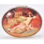 A large contemporary silver pill box with an enamel hinged lid depicting a a semi nude lady.