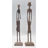 A pair of vintage 20th Century Tribal African bronze fertility figures of slender form. Raised on