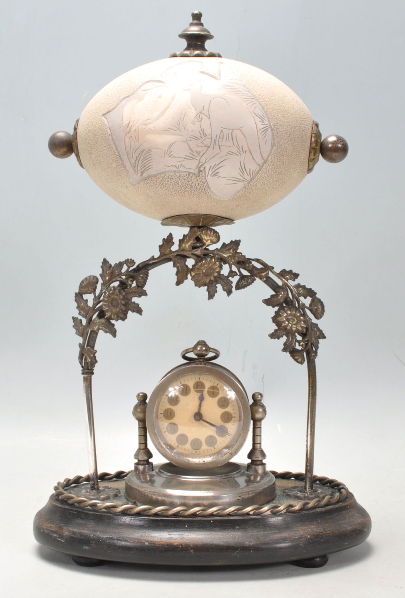A 19th Century Victorian carved emu egg mantle clock depicting a kangaroo and a large bird with an