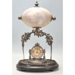 A 19th Century Victorian carved emu egg mantle clock depicting a kangaroo and a large bird with an