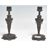 A pair of 19th Century cast bronze Grand Tour candlesticks having reeded cylindrical scones on