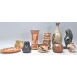 A mixed collection of Studio Art Pottery pieces to include a glazed bottle vase, chimney pot type