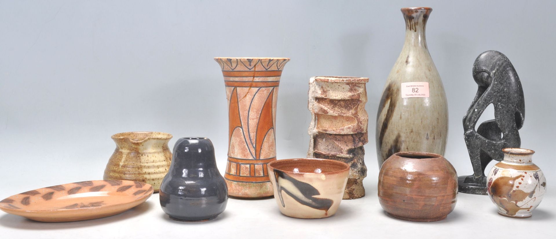 A mixed collection of Studio Art Pottery pieces to include a glazed bottle vase, chimney pot type