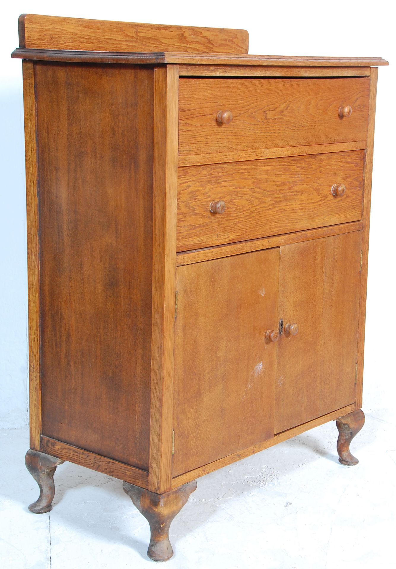 A early 20th Century oak tallboy chest of drawers - linen cupboard. The tallboy having two drawers