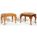 A near matching pair of vintage early 20th Century Queen Anne revival footstools. One of pine