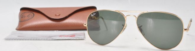A pair of  USA made Rayban gold tone Aviator sunglasses with leather case.
