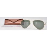 A pair of  USA made Rayban gold tone Aviator sunglasses with leather case.