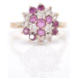 A 9ct gold hallmarked cluster ring. The ring set with amethyst and white mixed cut stones  in basket