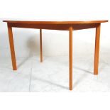 A retro mid 20th Century teak wood extending dining table of oval form raised on square tapering