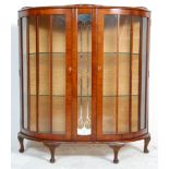 A 1930's Art Deco walnut veneered china display cabinet vitrine. Raised on cabriole legs with pad