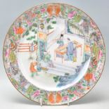 An 18th century Chinese antique porcelain plate depicting a scene of an elder inspecting a sword