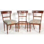 A group of three early 19th century Regency mahogany bar back dining chairs having knopped and