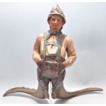 A large Carved German  - Bavarian wooden sculpture of a gentleman in lederhosens with horn legs -