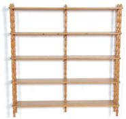 A good late 19th Century Victorian pine shelf rack having five shelves supported spindle turned