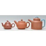 A collection of Chinese yixing teapots each of red clay terracotta form. To include a cylindrical