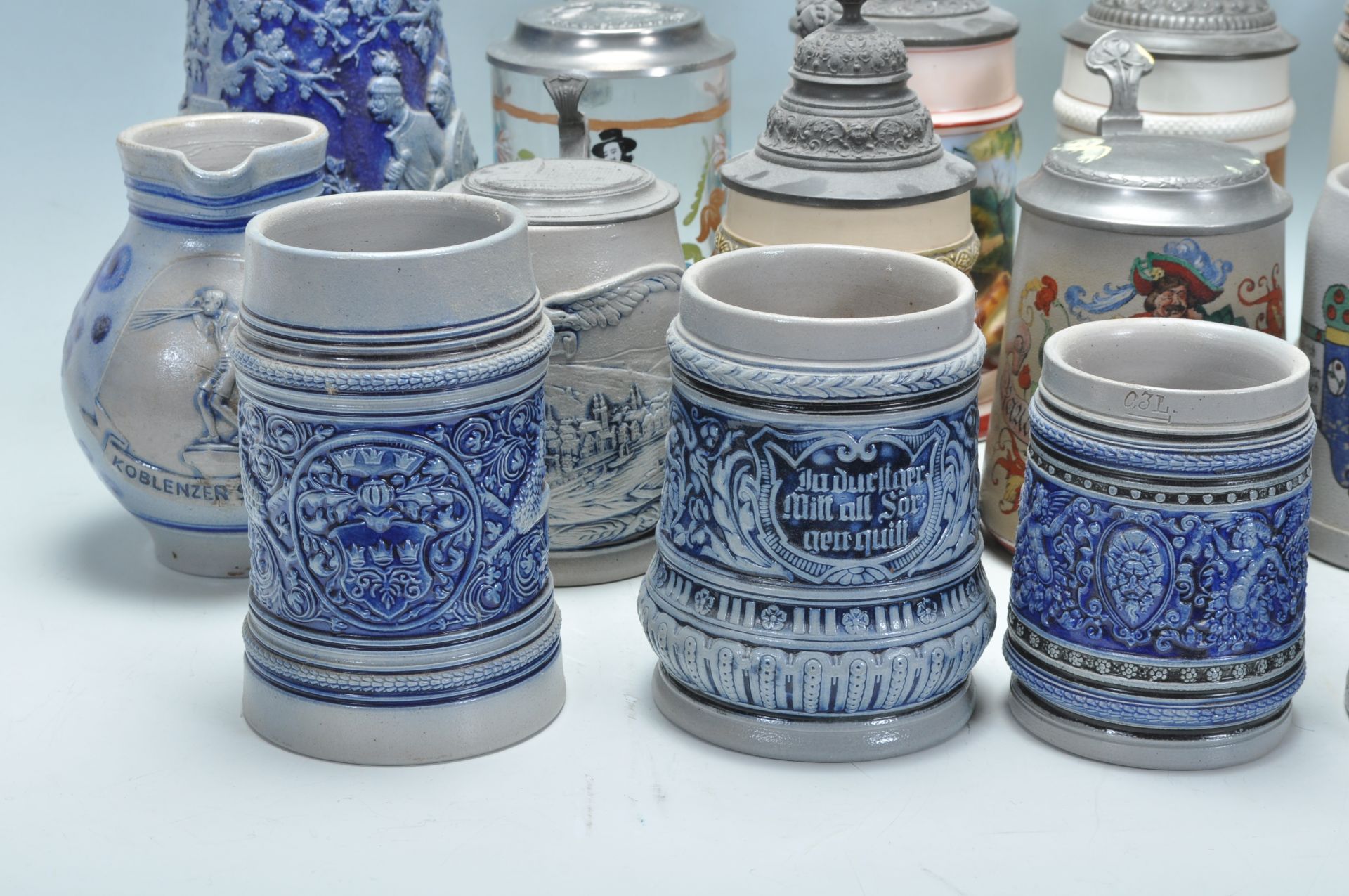 A collection of 20th Century German ceramic stein drinking glasses, many having raised blue and grey - Bild 3 aus 9