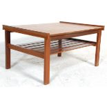 A retro mid 20th Century teak wood coffee table of square form having raised ends with slatted