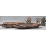 An interesting group of three African carved soapstone figures together with a matching pair of