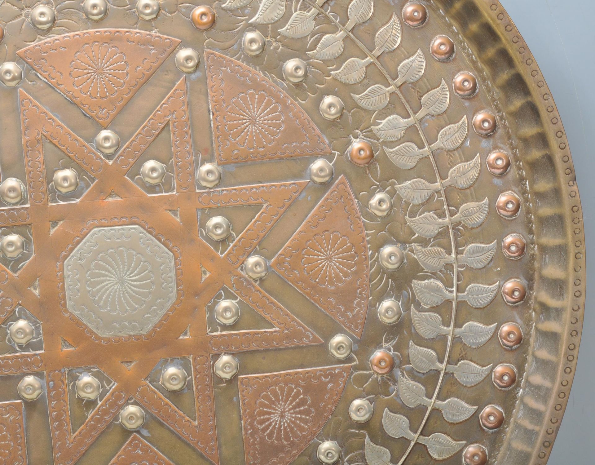 A 20th Century Middle Eastern brass and copper wall charger of circular form having inlaid white - Bild 6 aus 8