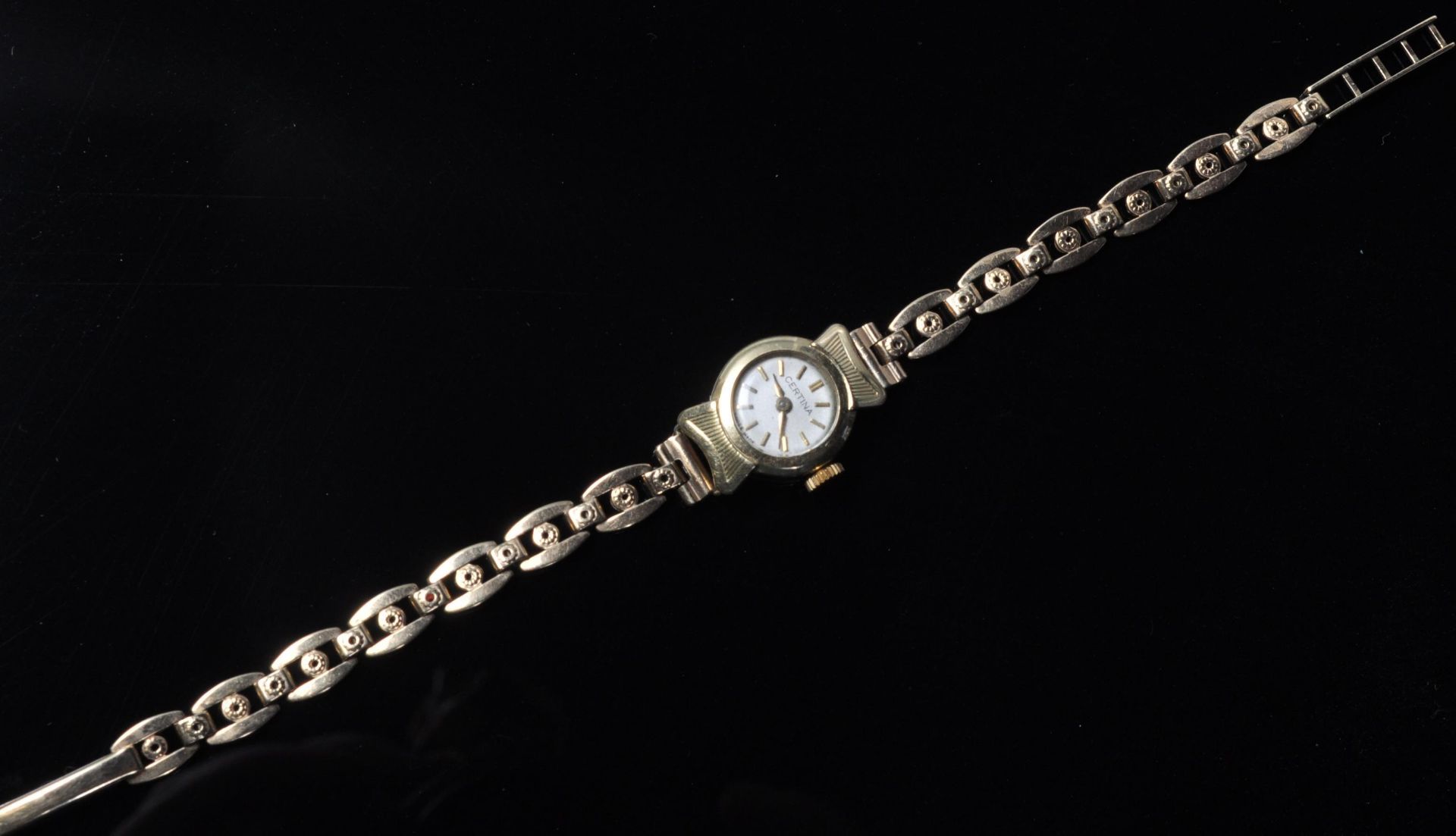 A vintage ladies 17 jewels Certina cocktail watch having a round face with gilt baton markings to