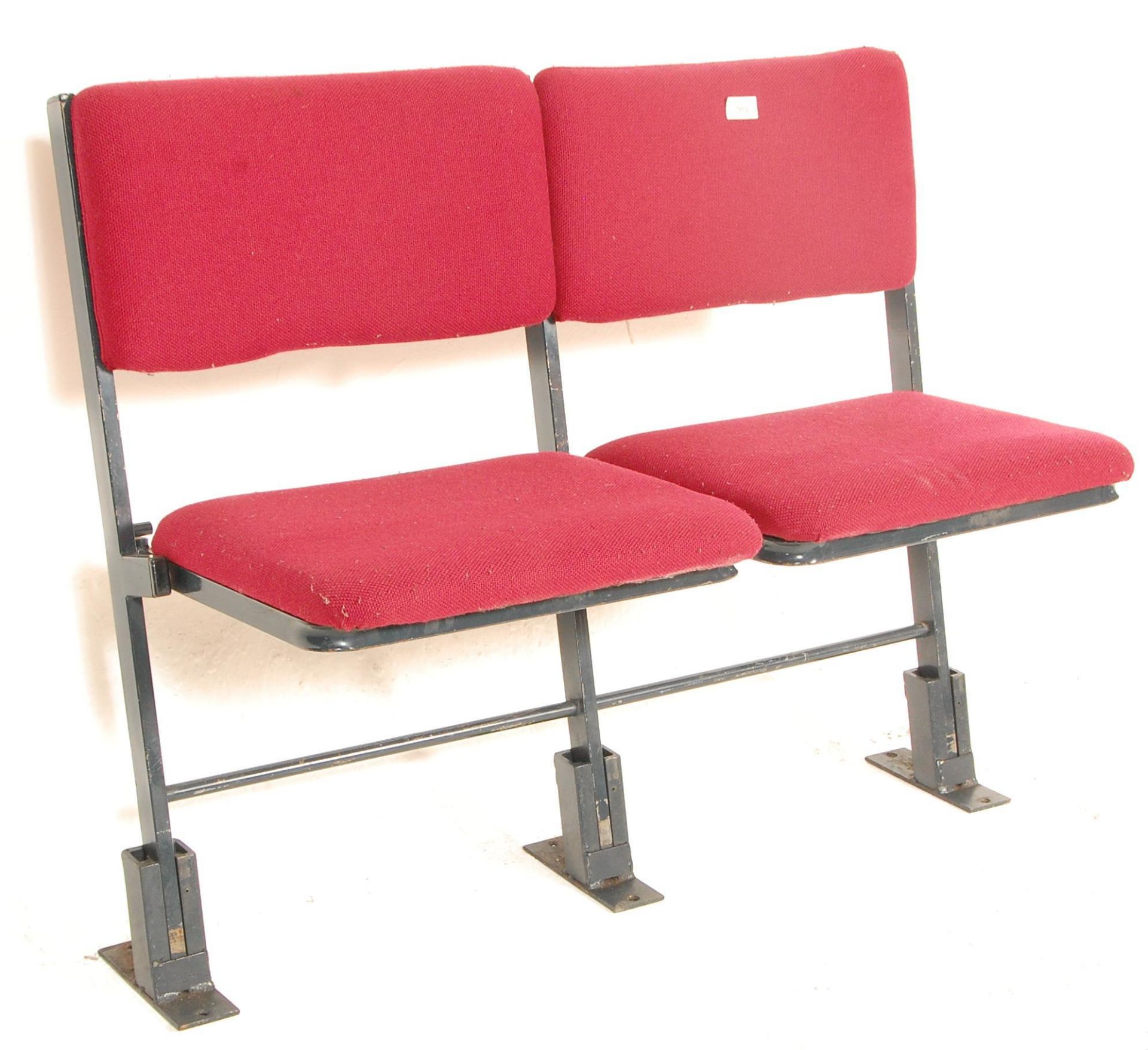 A set of two vintage retro 20th Century folding cinema / theatre chairs having red upholstered block