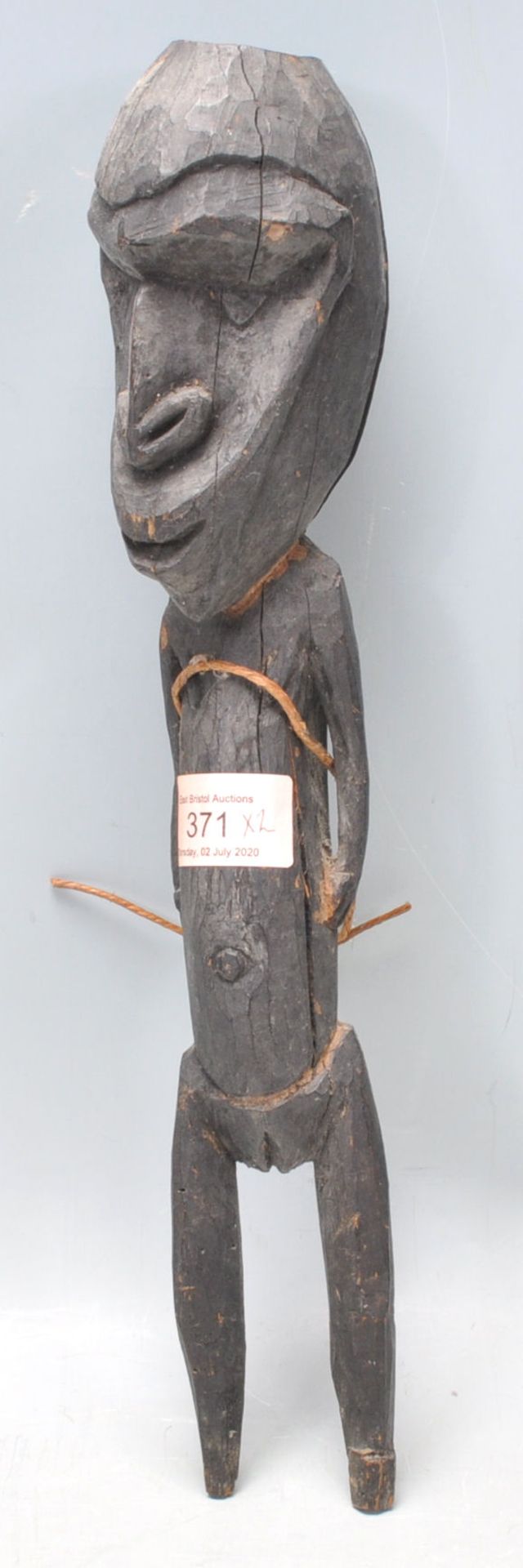 A carved tribal ebonised wooden figurine having an stylistically large head with short limbs - Bild 6 aus 9